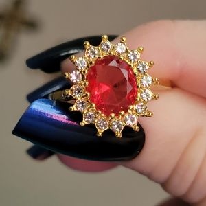18k gold filled 925 silver ruby with clear zircons all around. Size 7